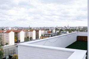 a view of a city from the roof of a building at Penthouse with rooftop in Colombes