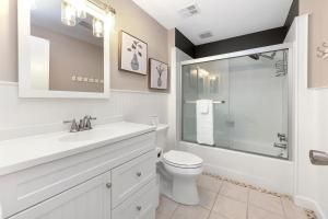 a bathroom with a toilet and a sink and a shower at Normandy Approach in Mooresville