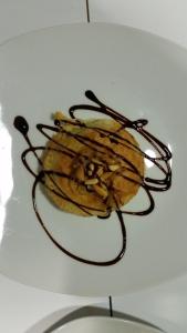 a dessert with chocolate sauce on a white plate at Un Rincón en la Mancha in Villar de Cañas