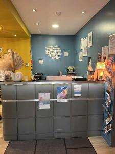 a counter in a store with signs on it at Hotel Best Western La Mare Ô Poissons in Ouistreham