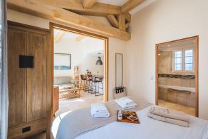 a bedroom with a bed with a large mirror at Les Maisons Du Sud in Saint-Tropez