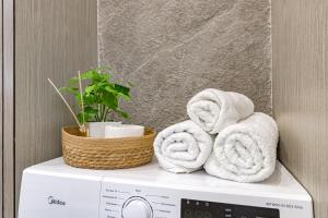 a stack of towels on top of a washing machine at Tokyo, a Residential Complex in Astana +88 photos