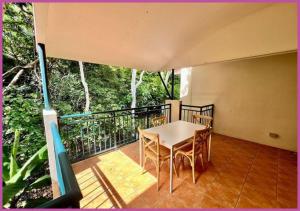 a porch with a table and chairs on a balcony at Riverside Boulevard 13-151 close to HOSPITAL in Ross River +2 photos
