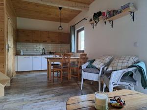 a kitchen and dining room with a table and chairs at Apartament Na Rozdrożu in Walim
