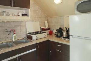 A kitchen or kitchenette at Bianka Apartman
