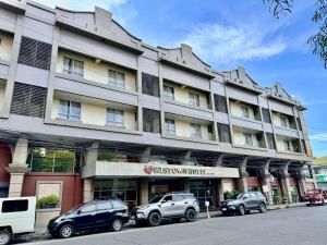 a large building with cars parked in front of it at MO2 Westown Hotel San Juan in Bacolod