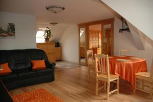 a living room with a table and a couch at Álom Kuckó Apartman in Zalaegerszeg