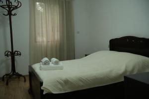 a bedroom with a bed with two towels on it at Rati's Oda in Aspindza +46 photos