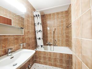 a bathroom with a tub and a sink at Studio Greppon 110 by Interhome in Les Collons