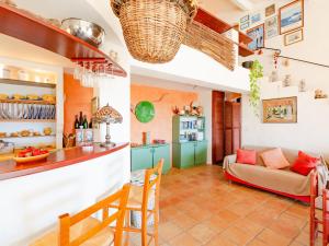 a kitchen and a living room with a couch at Holiday Home La Sacherie de l'Autourière by Interhome in La Garde-Freinet +15 photos