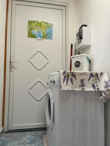 a washing machine in a room with a door at Roman Arch- low budget doublebed room in top center in Pula +5 photos