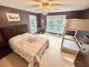 a bedroom with two bunk beds and a ceiling fan at Redbud Retreat in Centerville