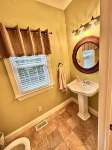a bathroom with a sink and a mirror at Redbud Retreat in Centerville +38 photos