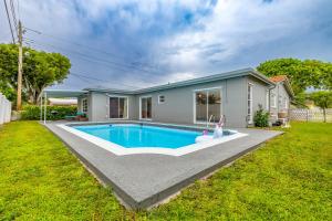 a house with a swimming pool in a yard at Margate Retreat Pool Near Beach Bbq in Margate