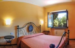 a bedroom with a bed with a red bedspread and a window at Tenuta Del Varco in Varco Sabino +36 photos