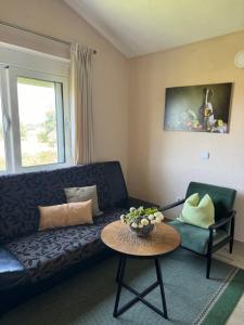 a living room with a couch and a table at Sunrise house apartments in Ulcinj