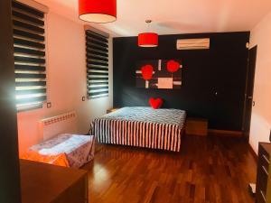 a bedroom with a bed and a black wall at La Mediterranea Village in Tarragona +16 photos