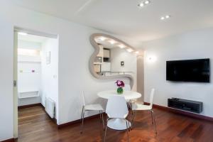 a white dining room with a white table and chairs at Apartment 18 in Belgrade