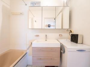 a bathroom with a sink and a bath tub at Studio Douceur de vivre nearby beach by Interhome in De Haan