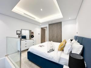 a bedroom with a large bed with a blue headboard at Trophy - Elevated Living in Luxurious Business Bay Loft in Dubai +28 photos