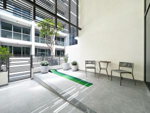 a patio with a table and chairs in a building at Trophy - Elevated Living in Luxurious Business Bay Loft in Dubai