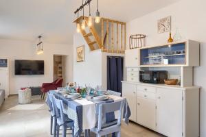 a dining room with a table and a kitchen at House Lando in Pula