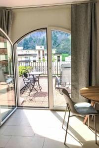 a room with a balcony with a table and chairs at Apartment B01 by Interhome in Leukerbad