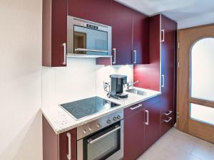 a kitchen with purple cabinets and a sink at Apartment B01 by Interhome in Leukerbad