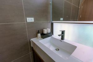 a bathroom with a white sink and a mirror at Villa A506 Hải Tiến, Thanh Hóa với 5 phòng ngủ tiện nghi in Thanh Hóa