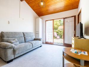a living room with a couch and a table at Holiday Home Les Maisons de l'Océan-3 by Interhome in La Palmyre