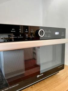 a microwave oven sitting on top of a wooden shelf at Chillige Ferienwohnung für 2! Loft A15 im Atelier in Fladungen