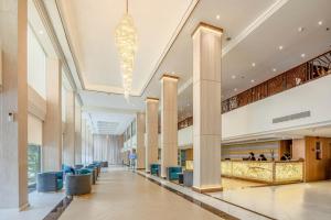 a large building with a lobby with a chandelier at The Maruay Garden Hotel in Bangkok