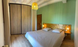sypialnia z łóżkiem i zieloną ścianą w obiekcie Villa Monbazillac, vue exceptionnelle, piscine, jacuzzi 10-12 pax w mieście Monbazillac