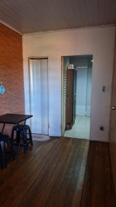 an empty room with a table and a hallway at Refrigerado Quarto sala cozinha e sacada in Cuiabá