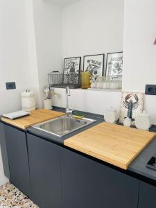 a kitchen with a sink and a wooden counter top at L'Adagio in Gran Madre in Turin +21 photos