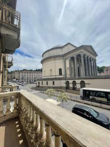 a building with a bus in front of a street at L'Adagio in Gran Madre in Turin