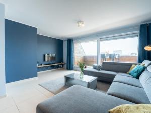 a blue living room with a couch and a table at Apartment Parklane-3 by Interhome in Bredene