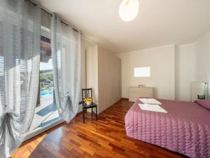 a bedroom with a purple bed and a large window at Apartment Alba Marina by Interhome in Citta' Sant'Angelo