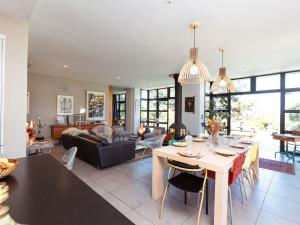 a living room with a table and a couch at Holiday Home La belle vue by Interhome in Cancale +31 photos