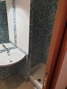 a bathroom with a sink and a mirror at Nettuno apartment city center sea view in Nettuno +33 photos