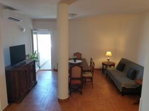 a living room with a couch and a table at Nettuno apartment city center sea view in Nettuno
