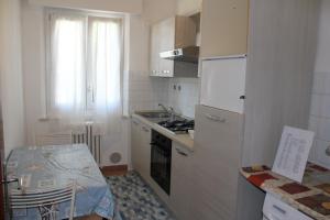 a small kitchen with a sink and a stove at La casa al mare in Marcelli