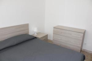 a bedroom with a bed and a dresser at La casa al mare in Marcelli