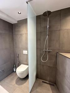 a bathroom with a shower and a toilet in it at Mario Rooms in Vlorë +60 photos