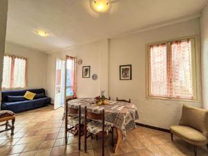 a living room with a table and a blue couch at Holiday Home Lidia by Interhome in Pianavia