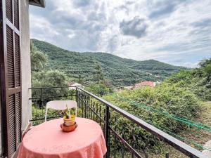 a table and a chair on a balcony with a view at Holiday Home Lidia by Interhome in Pianavia