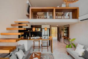 an open living room and kitchen with a loft at Samiik by Arkylab in Tulum
