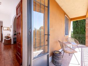 an open door to a balcony with a table and chairs at Holiday Home Podere Cavaceppi by Interhome in Pitigliano