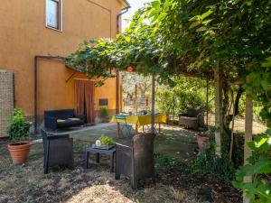 a patio with a table and chairs in a yard at Holiday Home Podere Cavaceppi by Interhome in Pitigliano