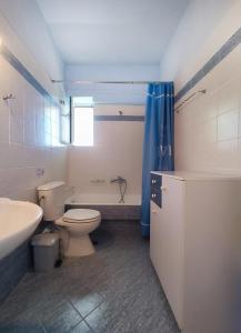 a bathroom with a toilet and a tub and a sink at AROKARIA HOUSE in Kanakia +30 photos